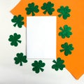 Happy St. PatrickÃ¢â¬â¢s Day. Shamrocks pattern and white mockup blank on white and orange background.